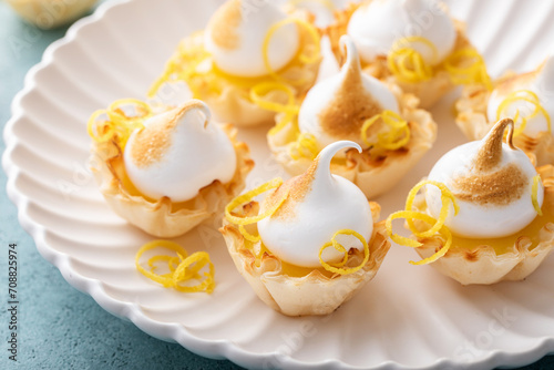Little lemon meringue tartlets with filo pastry base photo