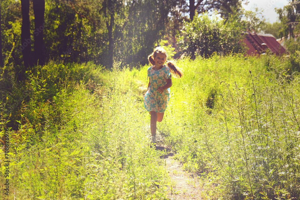 Naklejka premium Teenager girl in the meadow with raised hands, rear view. Running, dancing and enjoy. Summer sunset. Enjoying Life