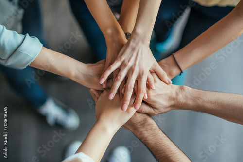 Close up top view of business people putting their hands together. Friends with stack of hands symbolizing their unity and support and teamwork. Team set up for productive work and a positive result.