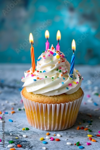 Celebratory Cupcake with Candles and Sprinkles on Festive Background