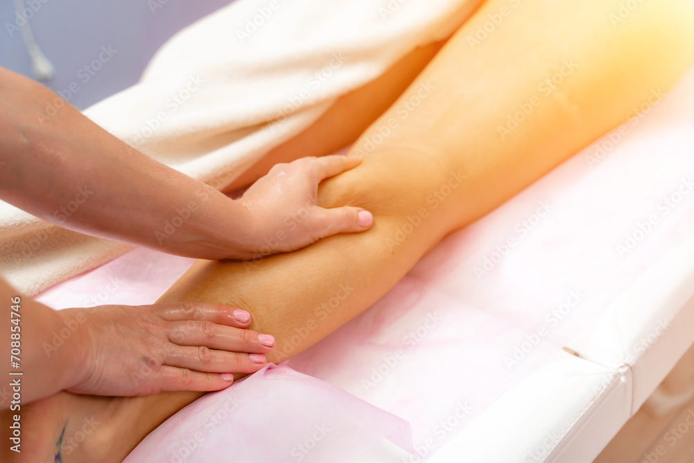 Facial massage. A woman is given a massage in a beauty salon. Close-up.