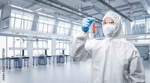 Foto Worker or scientist wears medical protective suit or white coverall suit hold te