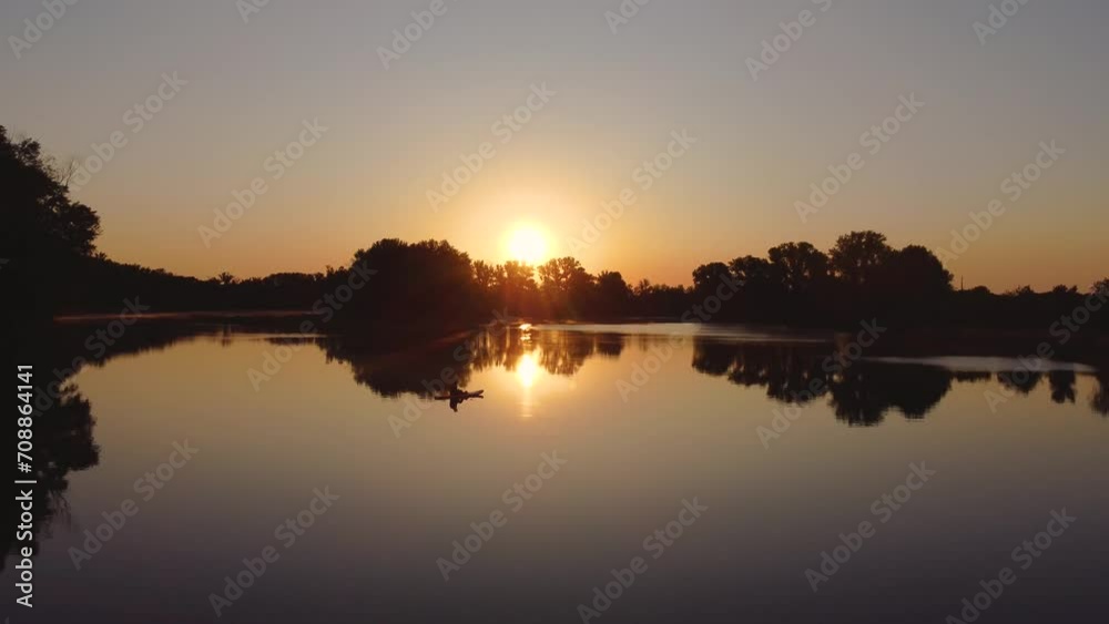 a man swims on a lake on a sap board at dawn a man swims on a lake on a sap board at dawn