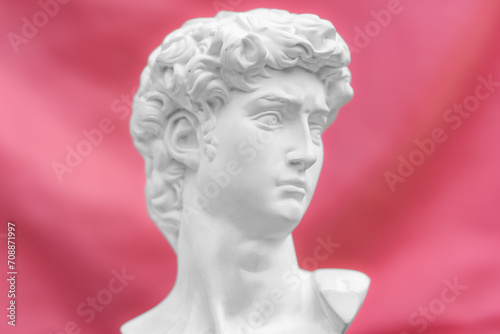  antique statue of david's head Concept of modern art and cyberpunk with pink background