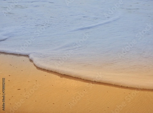 Closeup foam waves on beach, 