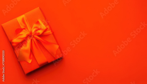 Flatlay of Valentines Day orange giftbox with red ribbon on orange background with copyspace © Михаил Таратонов
