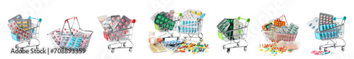 Set of small shopping carts and baskets with pills on white background photo