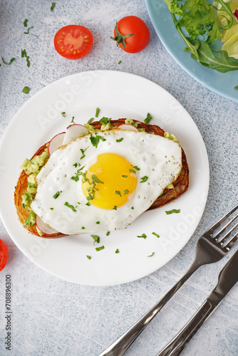 Delicious sandwich with fried egg on grunge background