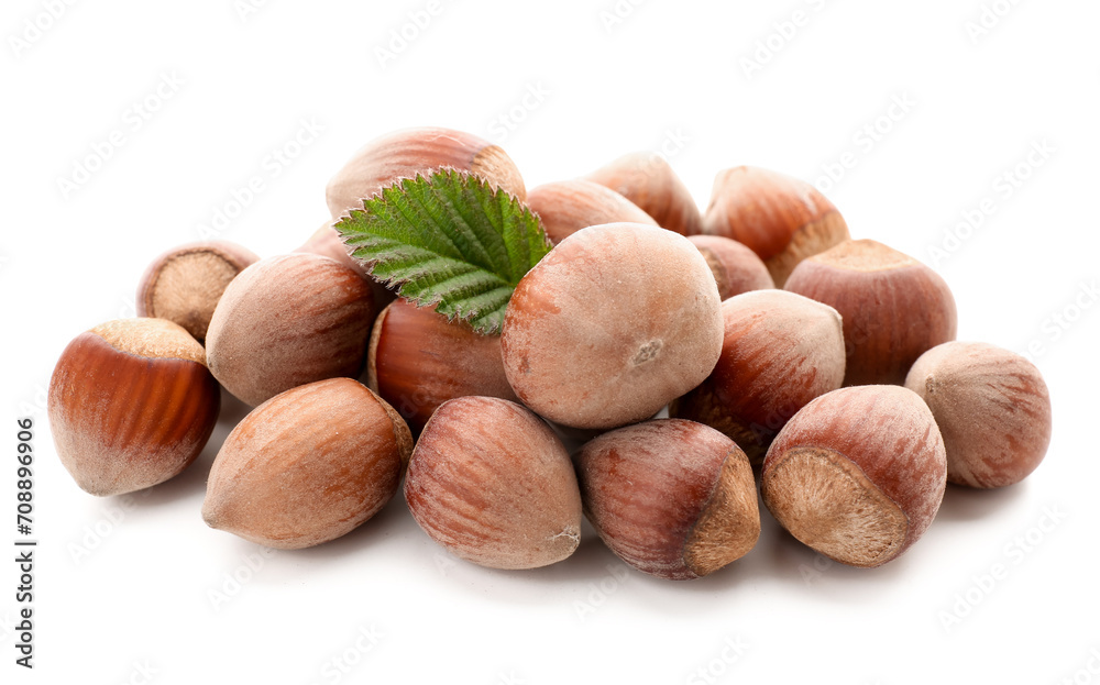 Shelled hazelnuts with leaf on white background Shelled hazelnuts with leaf on white background