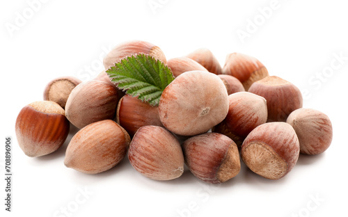 Shelled hazelnuts with leaf on white background