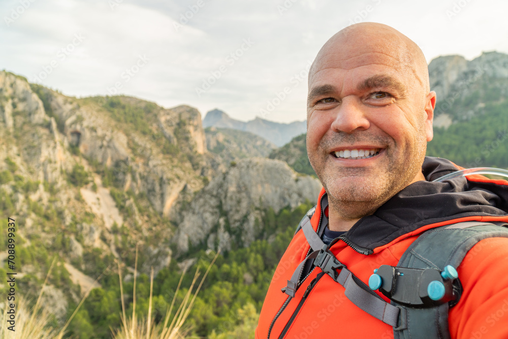 Cheerful hiker takes a selfie enjoying nature and mountains Cheerful hiker takes a selfie enjoying nature and mountains