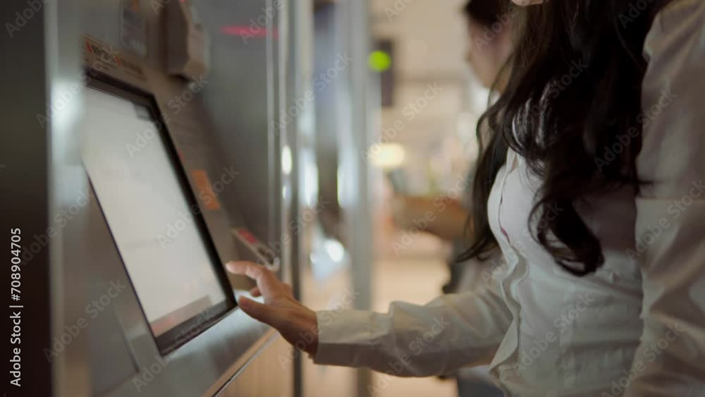 A business woman went to the station to buy a ticket after a business trip, touching the screen buy transport tickets
A business woman went to the station to buy a ticket after a business trip, touching the screen buy transport tickets