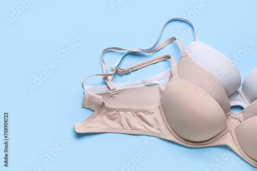 Set of bras on color background
