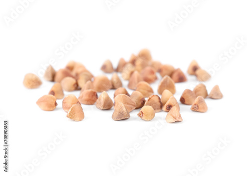 Many dry buckwheat grains isolated on white