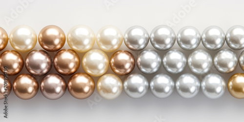 beautiful shining mother of pearl pearls in a row on a white background 