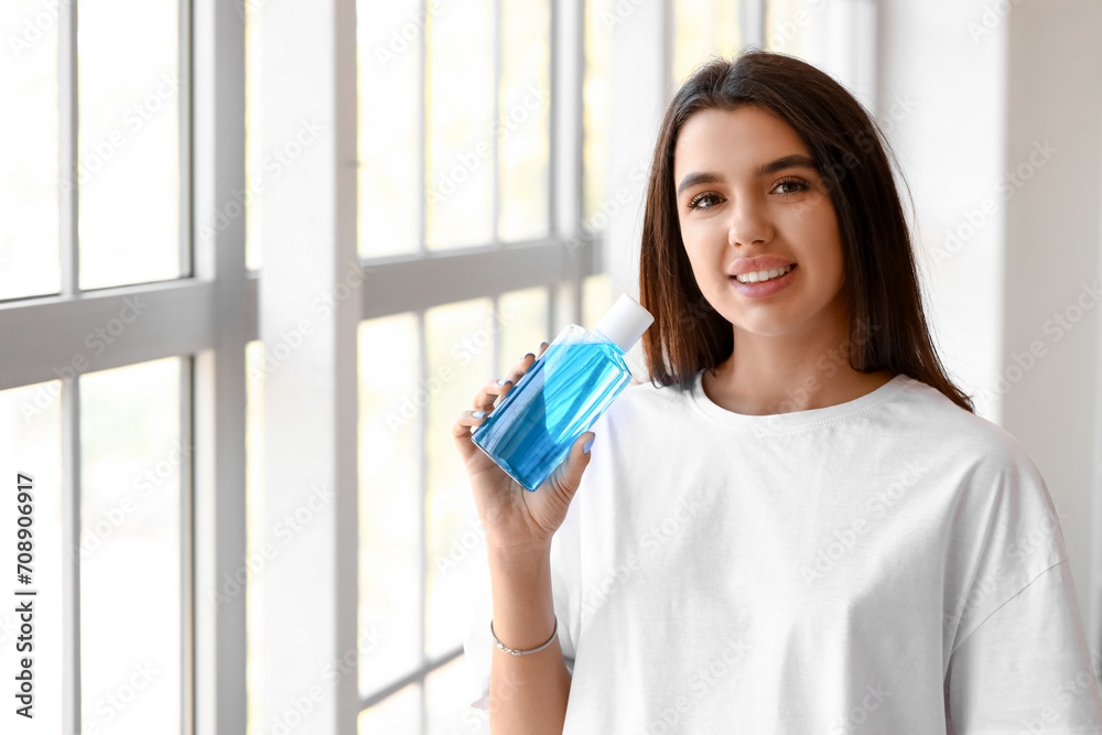 Smiling young woman with mouth rinse at home Smiling young woman with mouth rinse at home