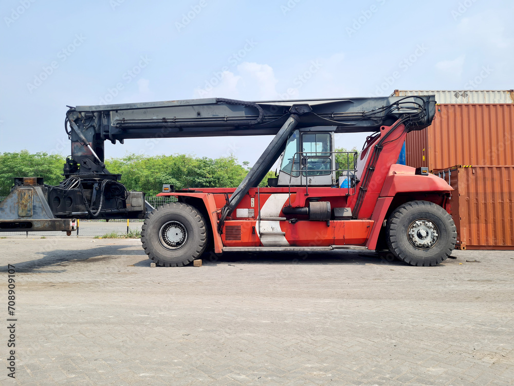 Logistics transportation industry forklift lifter container boxes at dock to truck for delivery of export and import trade goods at cargo port terminal port Logistics transportation industry forklift lifter container boxes at dock to truck for delivery of export and import trade goods at cargo port terminal port