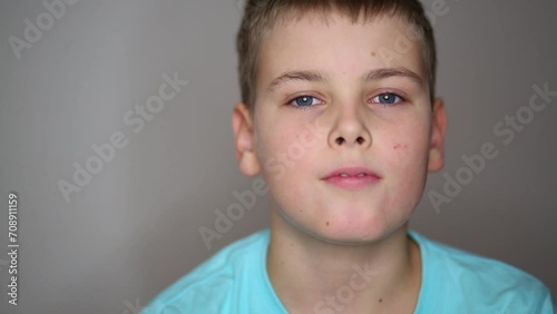 Portrait of handsome teen boy in blue T-shirt in studio photo