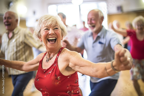 A scene of a group of seniors dancing joyfully in a fitness studio, illustrating the fun of group exercise. Selective focus, shallow depth of field