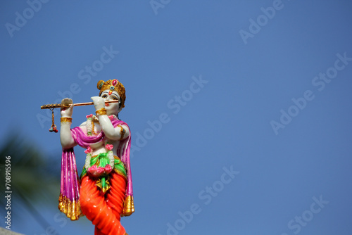 Lord sri krishna colorful statue with blue sky background photo