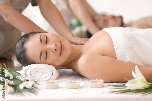 Young Asian woman getting massage in spa salon, closeup