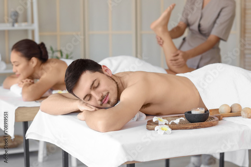 Young man with his wife relaxing in spa salon