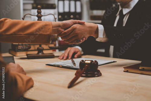 Lawyers shake hands with business people to seal a deal with partner lawyers. or a lawyer discussing contract agreements, handshake concepts, agreements.