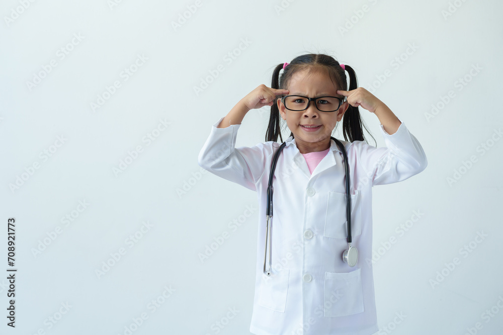 A young girl wearing a doctor's uniform and wearing glasses stands smiling and holds glasses playing doctor, showing various gestures, emotions, and imaginative thinking on a white background. A young girl wearing a doctor's uniform and wearing glasses stands smiling and holds glasses playing doctor, showing various gestures, emotions, and imaginative thinking on a white background.