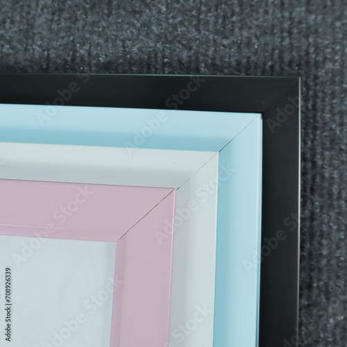 Blank picture frame on gray carpet in the room, stock photo