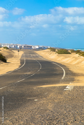 Country road with sand dunes to Caleta Famara in the Chinijo Natural Park near the village Teguise. Lanzarote, Spain, Europe photo