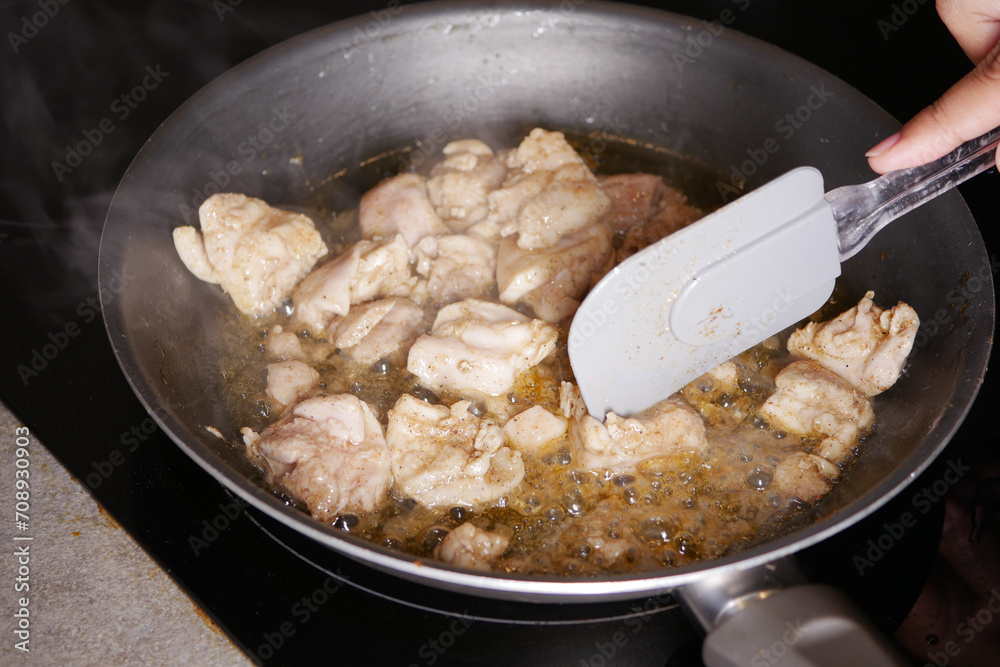 Chicken pieces fried in a cooking pan 