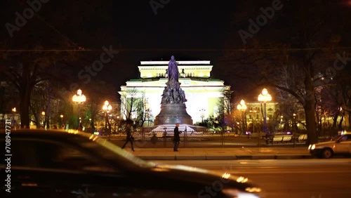 People and car traffic against Ostrovsky Square at night. photo