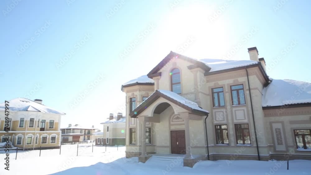 Covered with snow modern two-storey house on a sunny day Covered with snow modern two-storey house on a sunny day