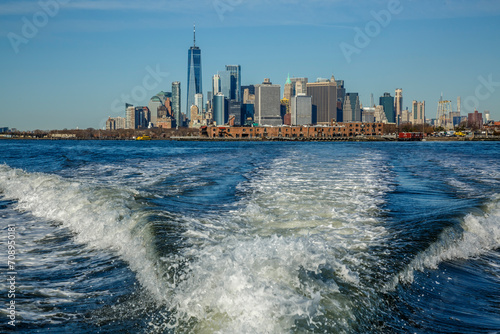 New York City panorama from a boat making waves in Hudson bay, USA