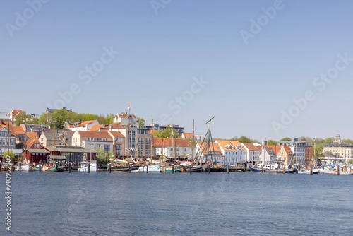 Happy walking along in Flensburg street (harbor) with old boats, Flensburg, Germany