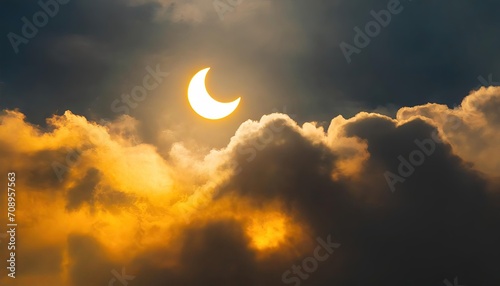 partial solar eclipse in a cloudy sky photo