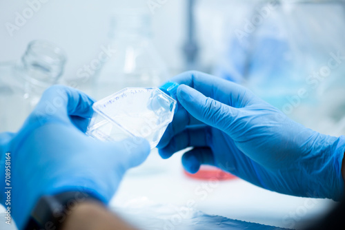 geneticist working with microplate for cells analysis in the genetic lab. Researcher working with samples of tissue culture in microplate in the bioengineering laboratory