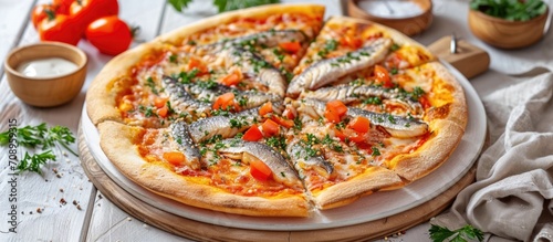 Authentic Roman pizza with fish, served on a white wooden board.