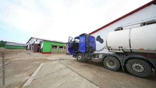 Truck for the production of milk loading stand near a barn. photo