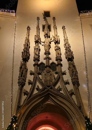 Decorative late gothic sculpture portal on tower of Old Town Hall in Brno, Czech Republic, made by Antonin Pilgram in year 1510. Lit by artificial lighting during winter christmas time.  photo