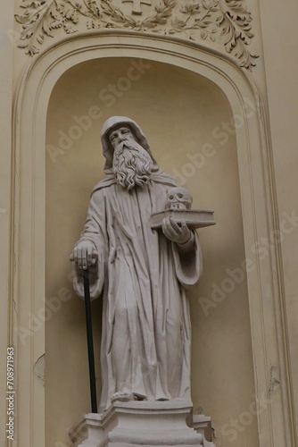 Картината върху платно Baroque statue of hooded bearded saint with book and skull in his left hand and walking stick in the right