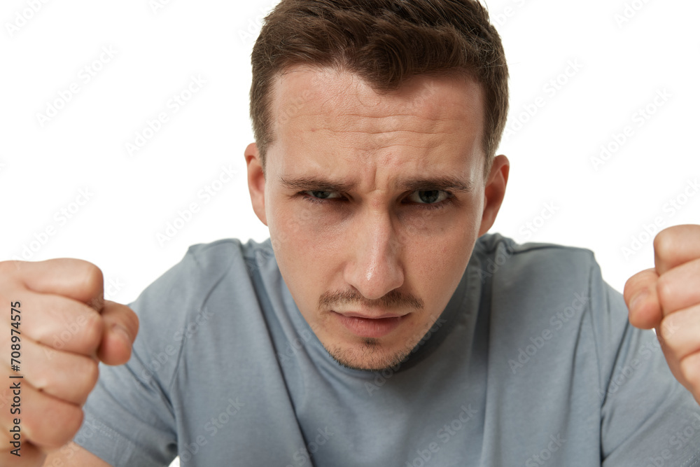 angry guy looking at camera on white studio background