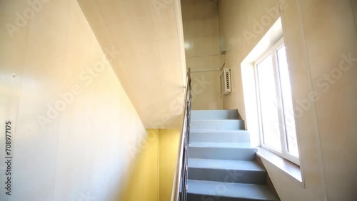 Simple empty staircase with a window in a modern office building photo