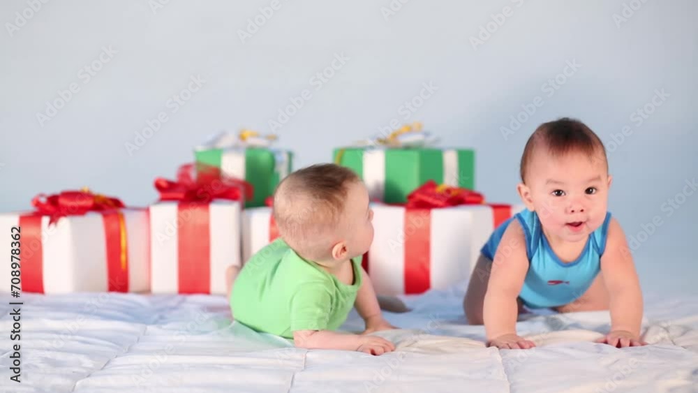 Two little babies near many large gift boxes in studio Two little babies near many large gift boxes in studio