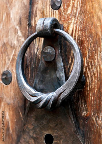 Fototapeta Naklejka Na Ścianę i Meble -  Metal ring door knocker on a medieval wooden door