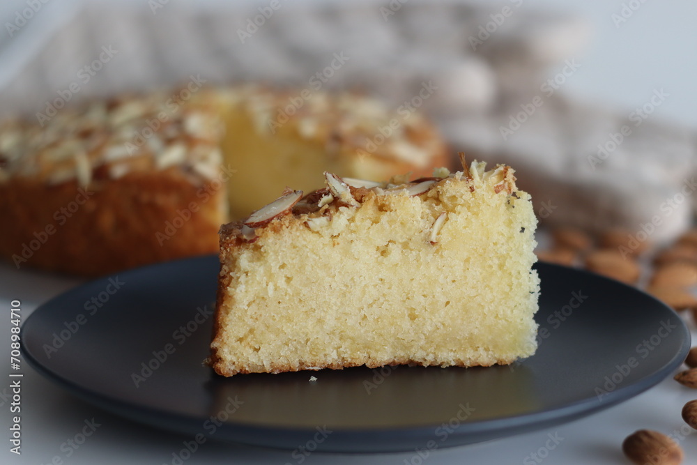 Sliced almond buttermilk cake. A delicious cake adorned with a generous sprinkle of chopped almonds, perfect for tea time Sliced almond buttermilk cake. A delicious cake adorned with a generous sprinkle of chopped almonds, perfect for tea time