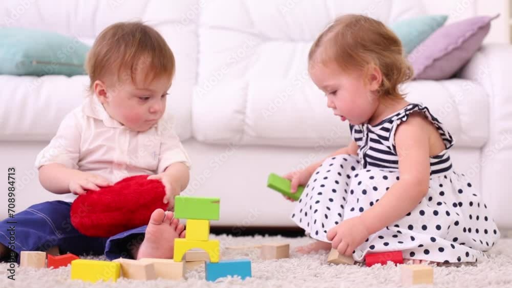 Cute little boy and girl play with tinker toys and soft heart Cute little boy and girl play with tinker toys and soft heart