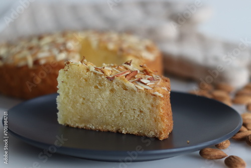 Sliced almond buttermilk cake. A delicious cake adorned with a generous sprinkle of chopped almonds, perfect for tea time