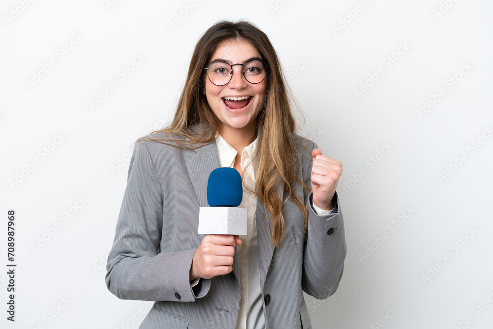 Young caucasian TV presenter woman isolated on white background celebrating a victory in winner position Young caucasian TV presenter woman isolated on white background celebrating a victory in winner position