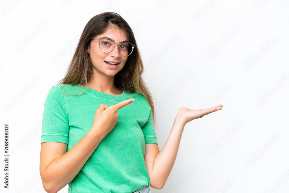 Young caucasian woman isolated on white background holding copyspace imaginary on the palm to insert an ad Young caucasian woman isolated on white background holding copyspace imaginary on the palm to insert an ad